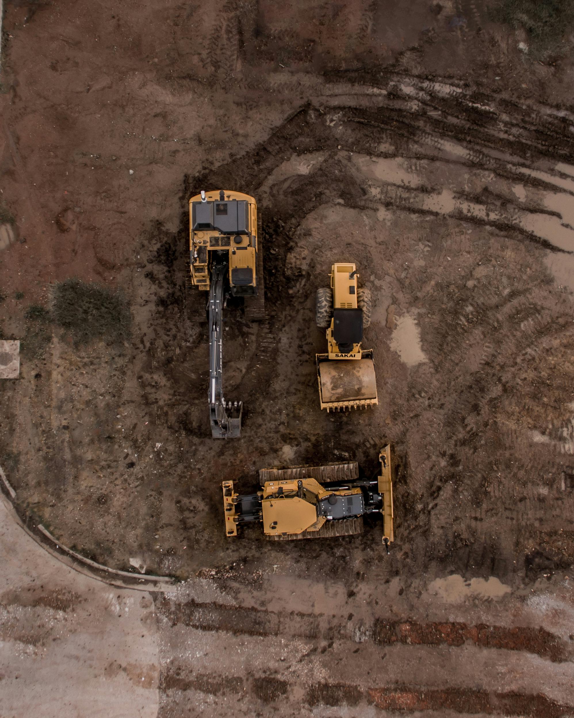 Aerial view of construction site with excavators and clean fill operations